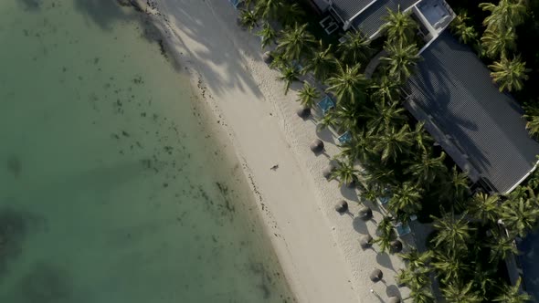 Aerial view of a blonde woman relaxing on the beach, Mauritius.