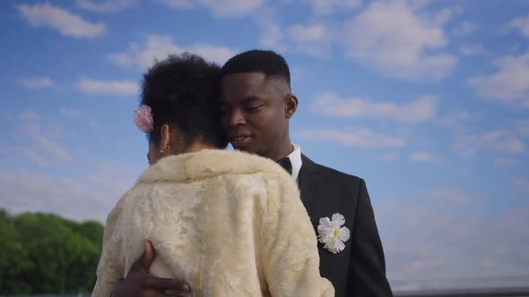 Portrait of Happy Groom Dancing First Dance with Bride on Bridge