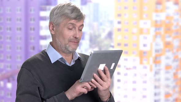 Mature Man Using Computer Tablet