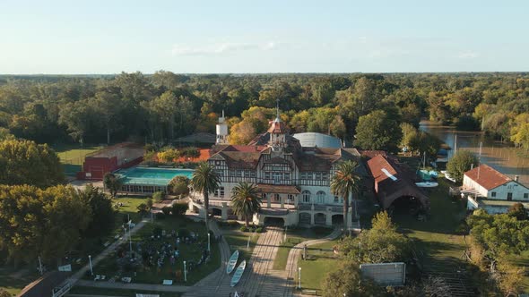 Aerial orbit of Regatas Las Marinas exclusive rowing club near de la Plata river surrounded by trees