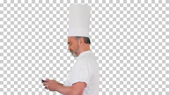 Senior chef in uniform using mobile phone, Alpha Channel