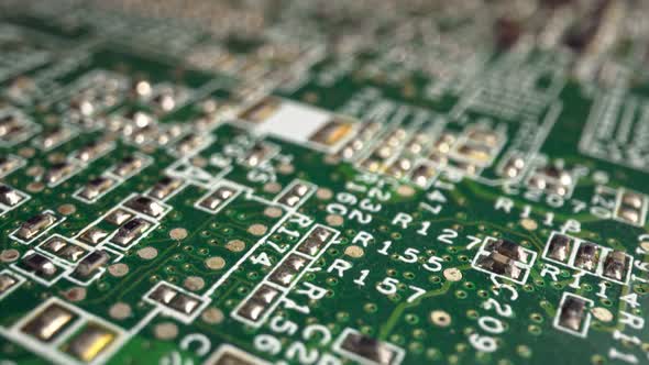 Extreme Closeup of Green Printed Circuit Board Electronics Shot with Dolly