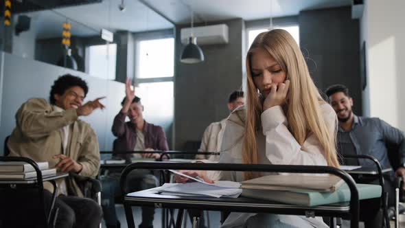 Sad Frustrated Insecure Girl Student Sitting in Classroom at Desk Suffering From Abuse Bad Attitude