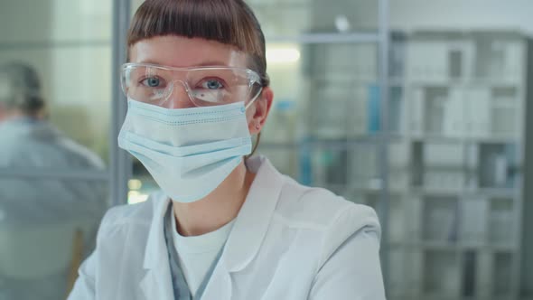 Portrait of Female Lab Scientist in Mask and Glasses