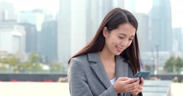 Business woman use of smart phone in city 