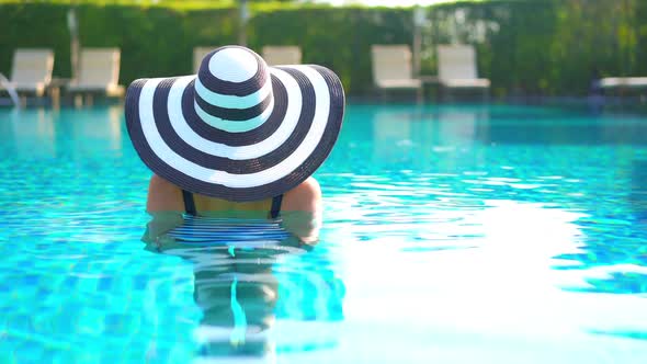 Young asian woman enjoy around outdoor swimming pool for leisure