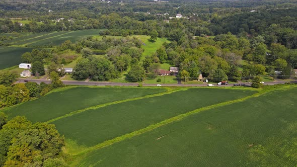 Aerial View of a American Countryside Village House Has a Large Garden with of Farm Fields in