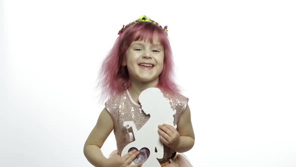 Girl Holds Holds Wooden Photo Frame in the Form of Pregnant Woman. Mother's Day