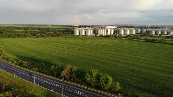 Green Field on the Background of Grain Elevators