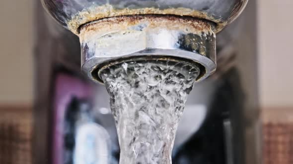 Faucet with Running Water in Slow Motion Macro Shot