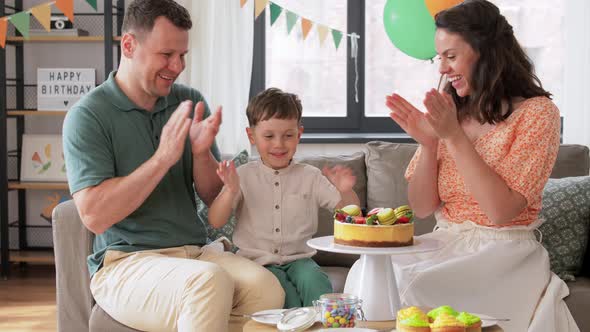 Happy Family with Birthday Cake at Home Party