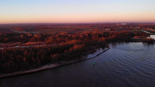 Aerial Rising Over Oude Maas With Autumnal Sunrise Fall Colours. Establishing Shot