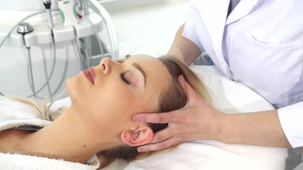 Cosmetologist Massages Client's Head