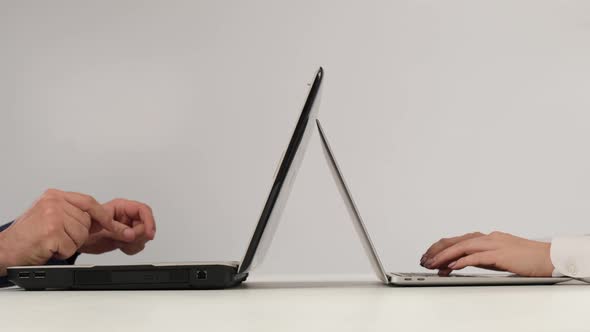 Man and Woman Work on Laptops on a White Background