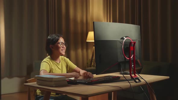 Asian Girl Learning Online From Home, Raising Hand Distance While Using Desktop Computer