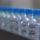 Closeup of PET Bottles Moving Along a Conveyor Line of Industrial Equipment - VideoHive Item for Sale