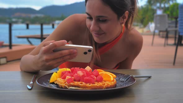 Woman Photographing Food on Smartphone