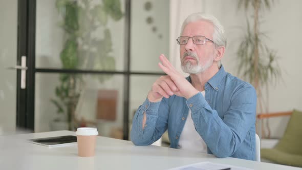 Pensive Senior Old Man Sitting in Office Thinking