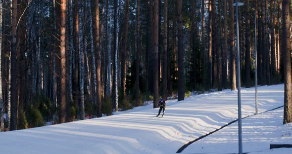 Skier Sports Man Ride From Hill at Snowy Woodland