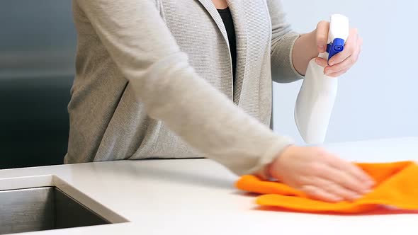 Woman cleaning kitchen worktop