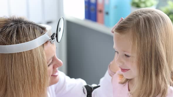 ENT Doctor Examining Little Girl Ear Using Otoscope  Movie Slow Motion