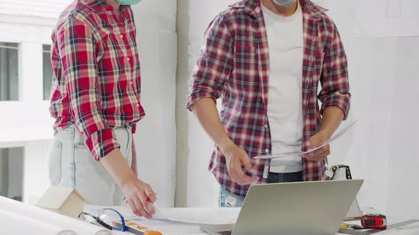 Two architect and male contractor working together on projects.