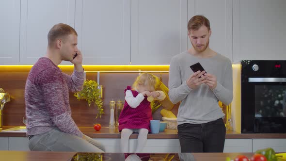 Same Sex Parents and Daughter Taking Selfie at Home