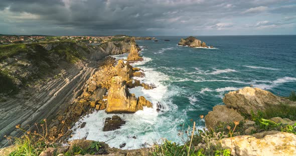  Timelapse View of Reefs and Cliffs During Sunrise at Arnia Beach. Northern Spain in Summer.