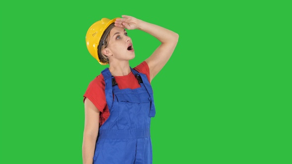 Engineer construction worker woman looking up amazed on