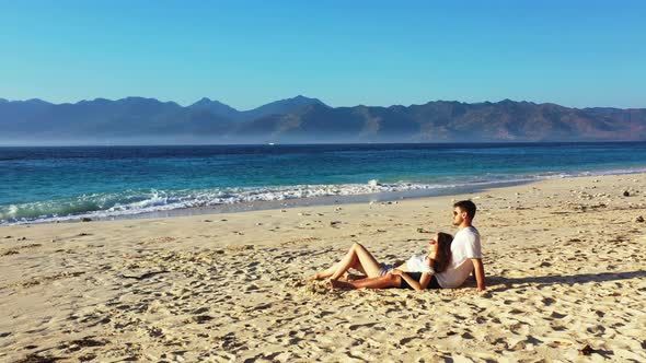 Young people on honeymoon vacation enjoy life on beach on sunny white sandy background 4K