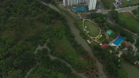 drone shot flying over wetlands to a modern high rise development on the outskirts of Ho Chi Minh Ci