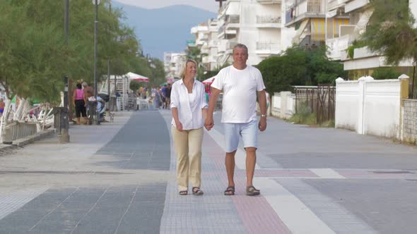 Couple of Man and Woman Walking Down the Street