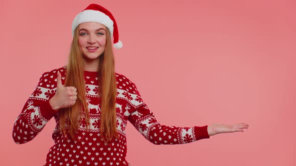 Woman Wears Red New Year Sweater Deer Showing Thumbs Up and Pointing at on Blank Advertisement Space