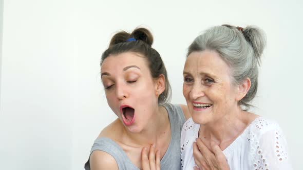 Happy Senior Mother is Hugging Her Adult Daughter the Women are Laughing Together Sincere Family of