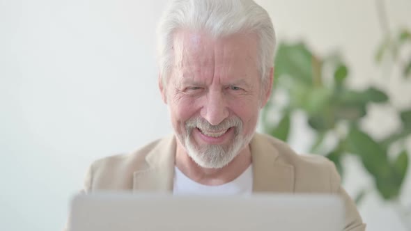 Close Up of Old Man Celebrating Success While Using Laptop in Office