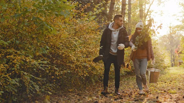 Young Couple in Love Happy People Walking in Autumn Park Talking at Sunset Enjoying Nature