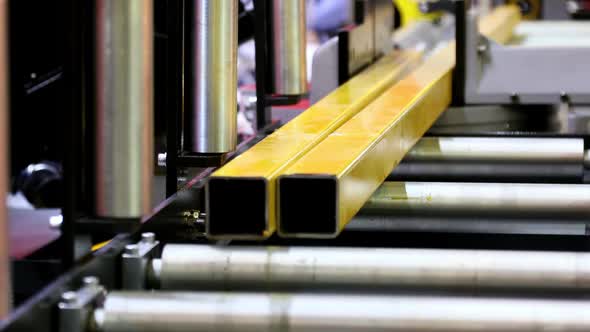 Metal Part Moves Along the Rollers of the Machine in Production