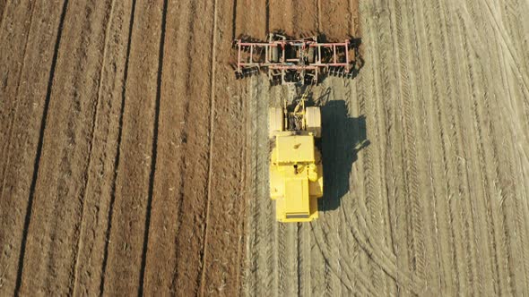 Tractor with Disc Harrows on the Farmland