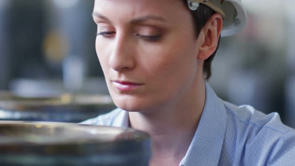 Female Factory Supervisor Checking Product