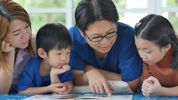 Happy Asian Family Reading Book At Home