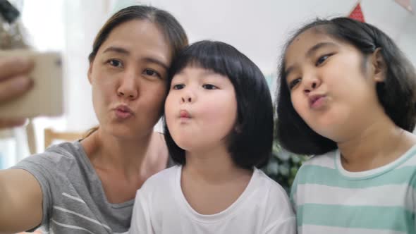 Slow motion Happiness moment at home, Happy Asian family take selfie photo together.