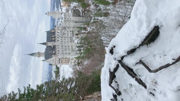 Vertical Footage of The Famous Bavarian Place Royal Castle Neuschwanstein at Winter Day Clouds Sky