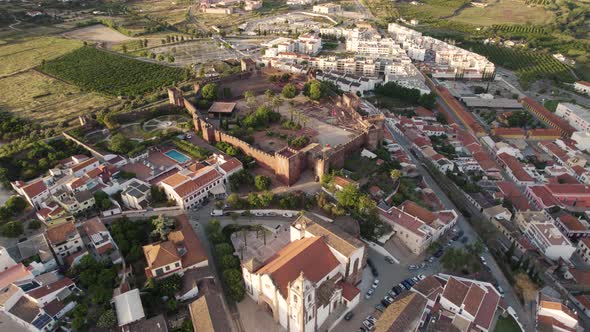 Rising aerial over the church and castle in Silves, Portugal