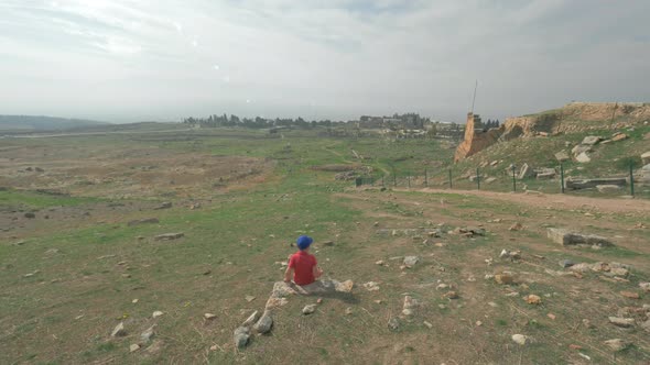 Child Looking at Ruins of Ancient City Hierapolis in Pamukkale, Turkey