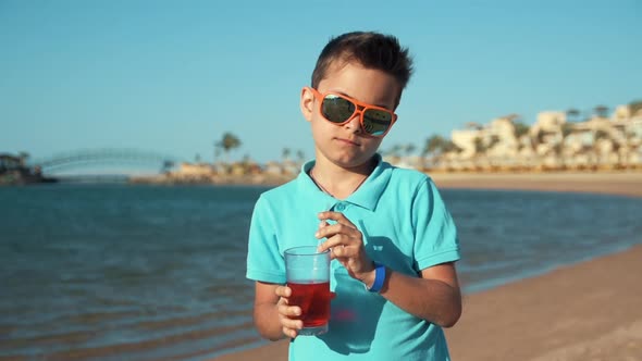 Attractive Young Man in Sunglasses Enjoying Summer Holiday at Sunny Seaside.