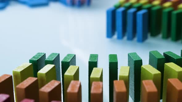 Line up of Dominoes in Rainbow Falling Colors with LGBT Colors of a Hand