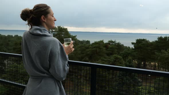 Beautiful Lady Enjoying Sea View From the Balcony