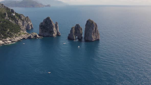 Famous Italy Travel Destination: Faraglioni Rocks on Coast of Capri, Island - Aerial