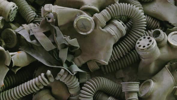 A Pile Of Gas Masks On The floor Inside The Abandoned School In Chernobyl  Exclusion Zone, Ukraine.-