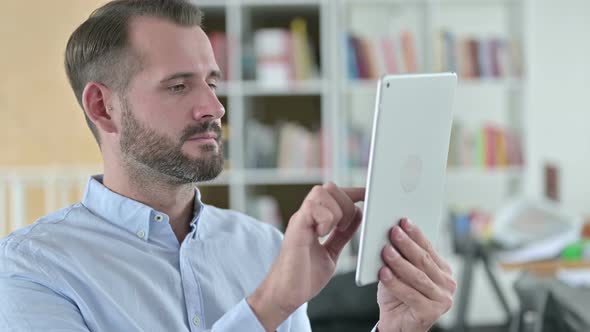 Portrait of Professional Young Man Using Tablet